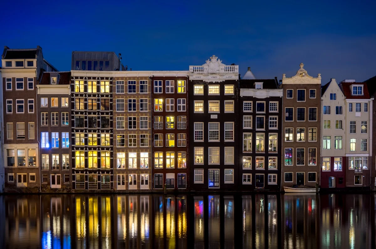 Apartment windows at night — each one a different story